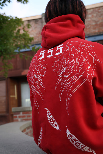 Back view of Rebirth Angel Wings Oversize Hoodie in burgundy showing falling feathers design and premium heavyweight cotton blend